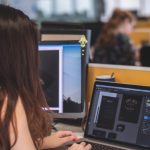 woman in front of laptop computer editing photo
